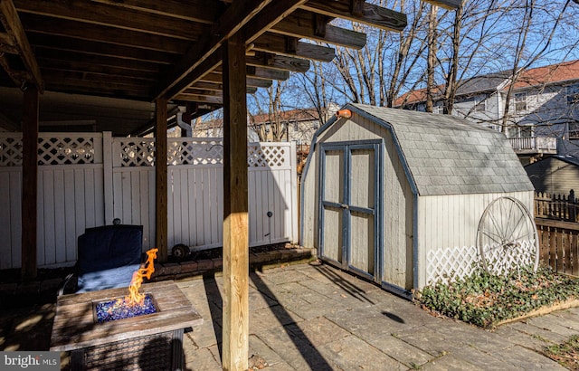 view of outdoor structure featuring an outdoor fire pit