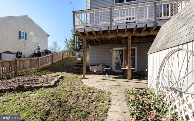 view of yard with a wooden deck and a patio area