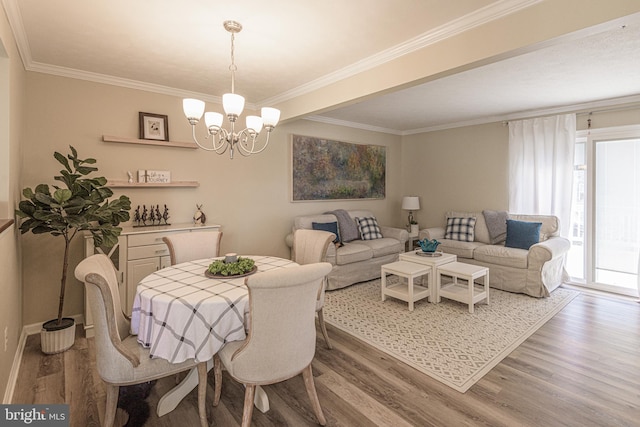 dining room with an inviting chandelier, crown molding, and wood-type flooring