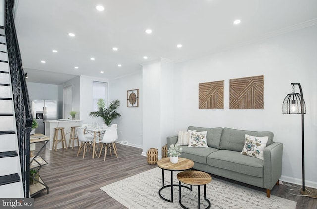 living room featuring hardwood / wood-style floors and ornamental molding