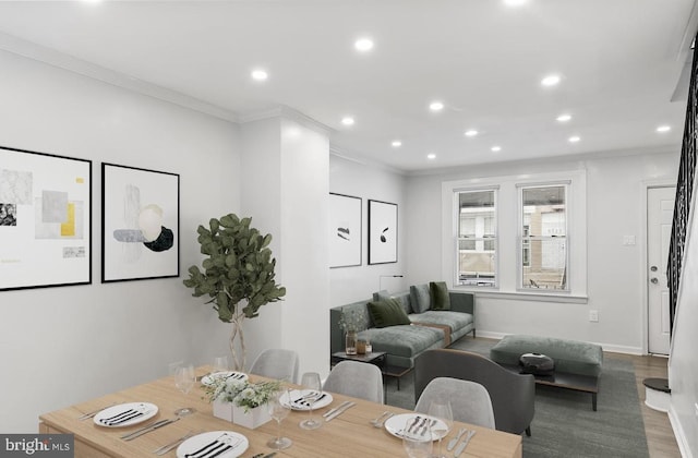 dining area featuring hardwood / wood-style flooring and crown molding