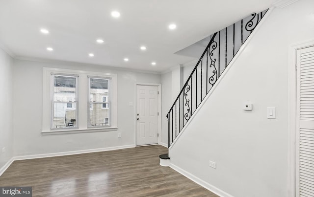 foyer with crown molding and dark hardwood / wood-style floors