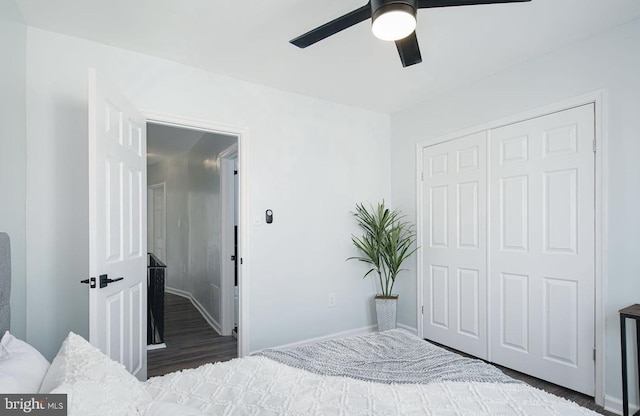 bedroom with a closet, ceiling fan, and dark hardwood / wood-style floors