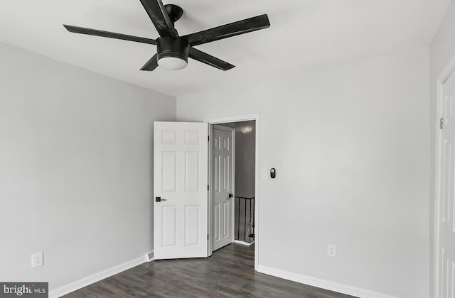 unfurnished bedroom with ceiling fan and dark hardwood / wood-style flooring