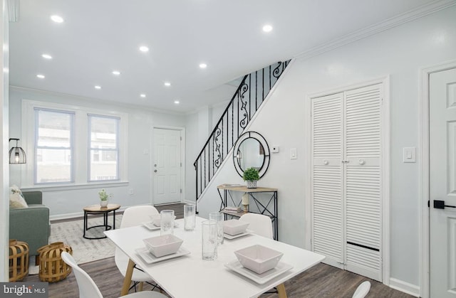 dining area with crown molding and wood-type flooring