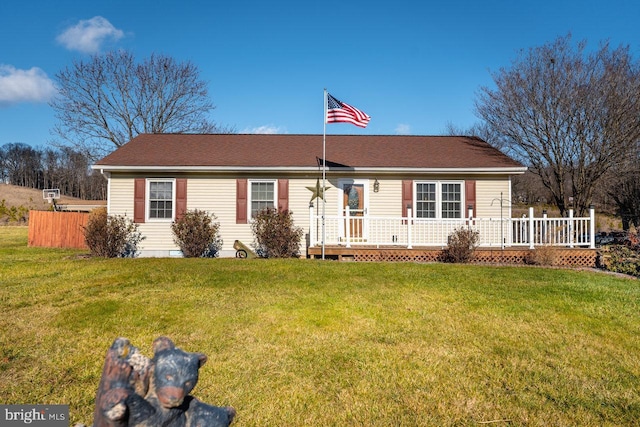 ranch-style house featuring a deck and a front lawn