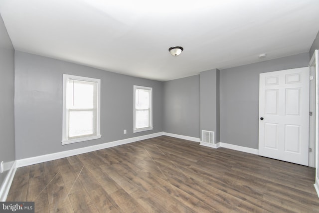 spare room with dark hardwood / wood-style floors