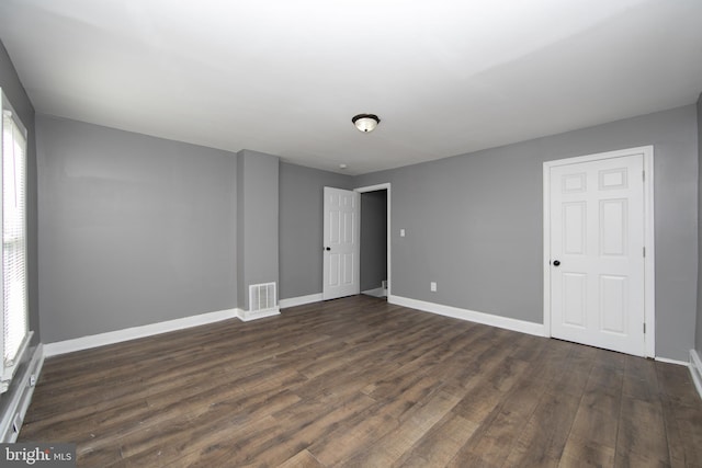 spare room with dark wood-type flooring