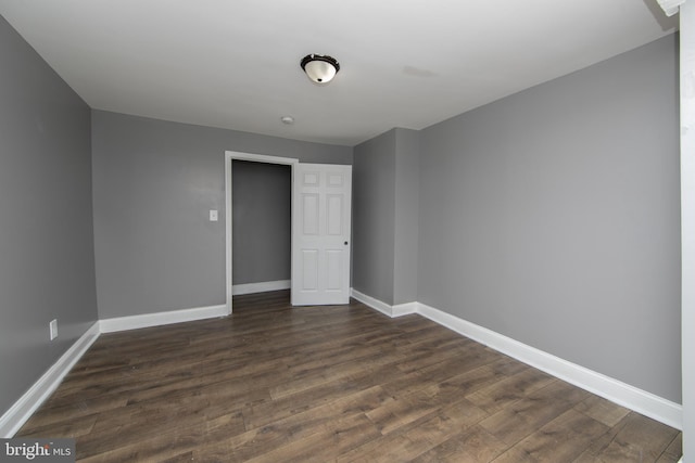 empty room featuring dark hardwood / wood-style flooring