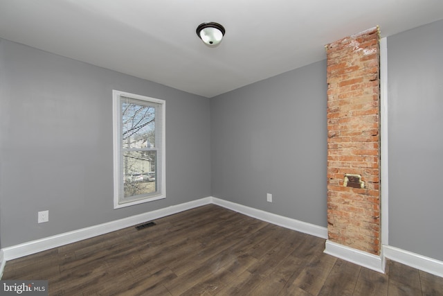 empty room featuring dark wood-type flooring