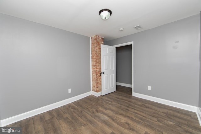 empty room with dark hardwood / wood-style floors