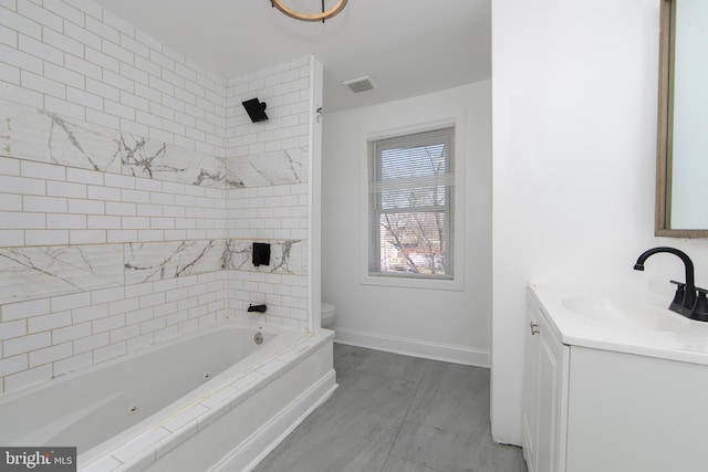 full bathroom featuring toilet, vanity, and tiled shower / bath