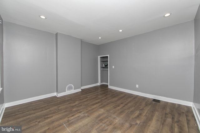 unfurnished room with dark hardwood / wood-style flooring