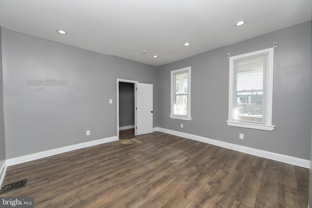 unfurnished room featuring dark wood-type flooring