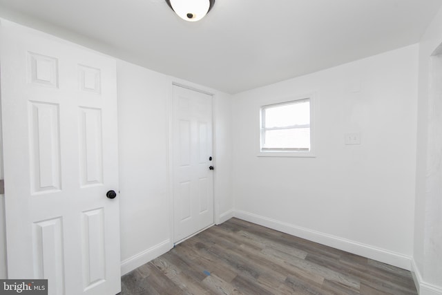 unfurnished room with dark hardwood / wood-style floors