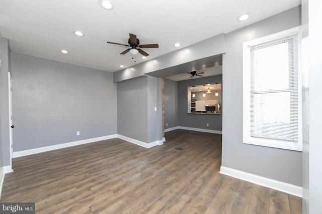 unfurnished living room with ceiling fan and dark hardwood / wood-style flooring