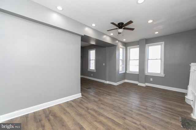 unfurnished living room with ceiling fan and dark hardwood / wood-style flooring