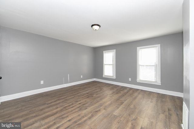 unfurnished room featuring dark hardwood / wood-style flooring