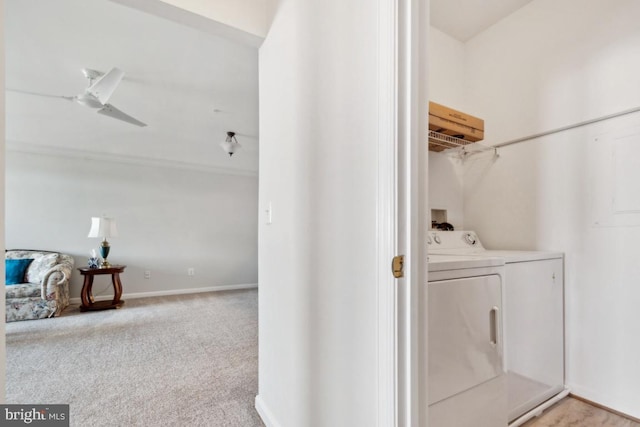 laundry area featuring light carpet and washing machine and dryer