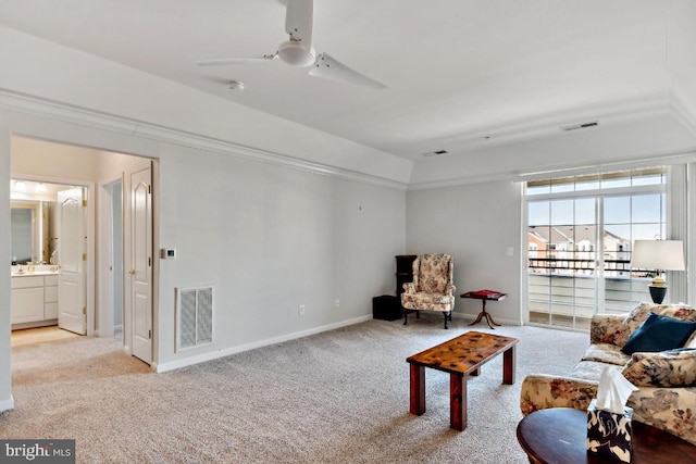 living area with ceiling fan and light carpet