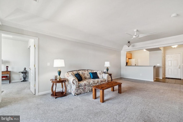 living room featuring ceiling fan and carpet