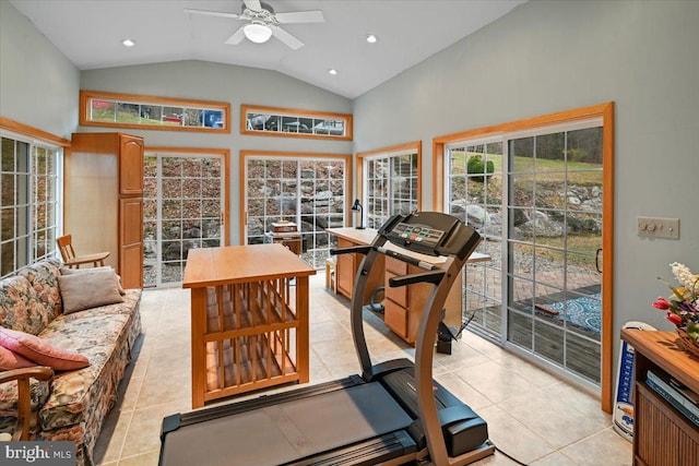 exercise room with lofted ceiling, ceiling fan, and light tile patterned flooring