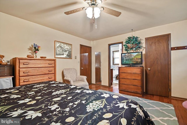 bedroom featuring ceiling fan, wood-type flooring, and connected bathroom