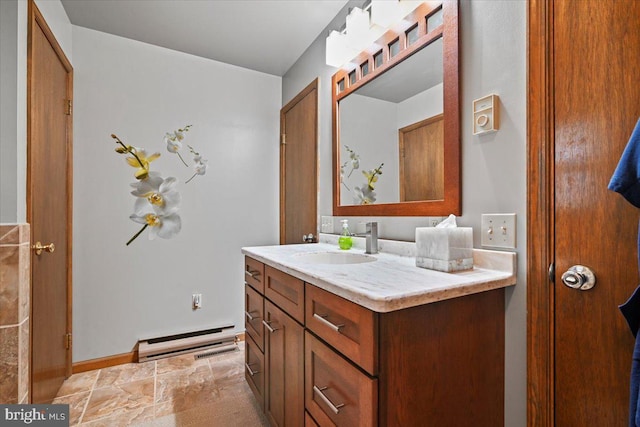 bathroom featuring a baseboard heating unit and vanity