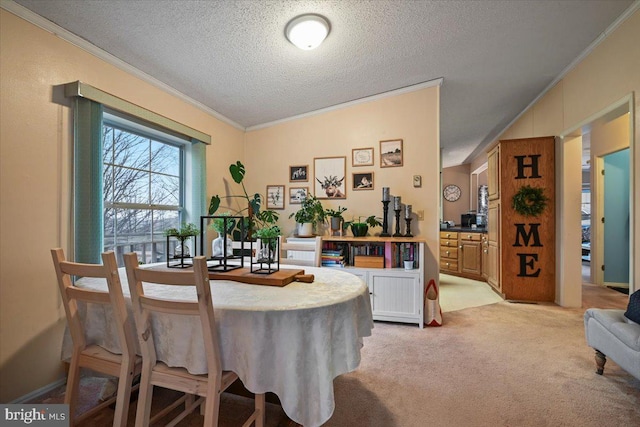 carpeted dining area with a textured ceiling and ornamental molding