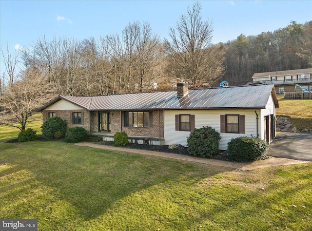 ranch-style home with a front lawn and a garage