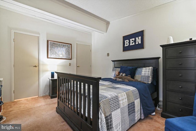 carpeted bedroom with a textured ceiling and ornamental molding