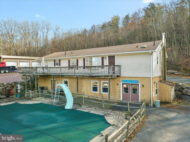 back of house featuring a balcony and a patio