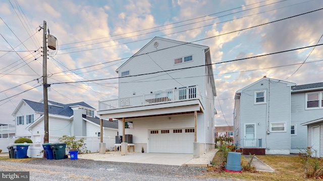 view of front of home with a balcony and a garage