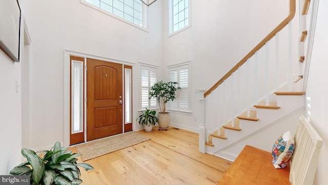 entrance foyer featuring a high ceiling and hardwood / wood-style flooring