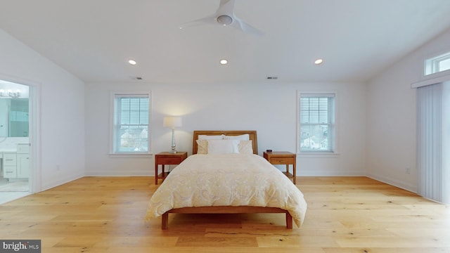 bedroom featuring ensuite bath, light wood-type flooring, and ceiling fan