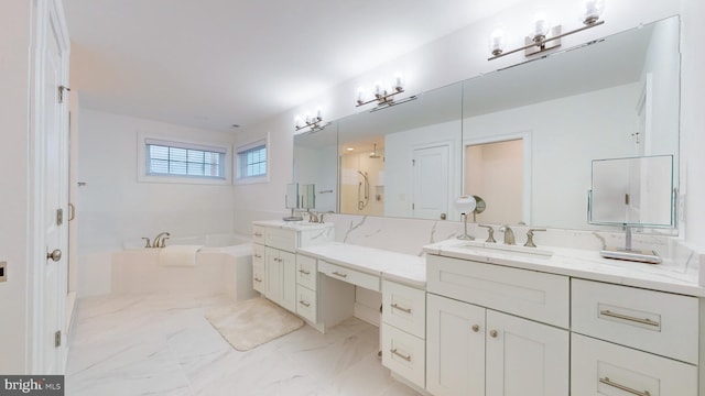 bathroom with vanity and independent shower and bath