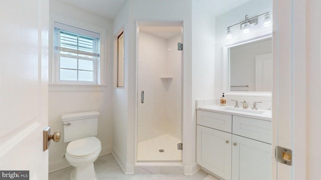 bathroom featuring toilet, a shower with door, and vanity