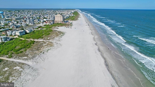 drone / aerial view with a beach view and a water view