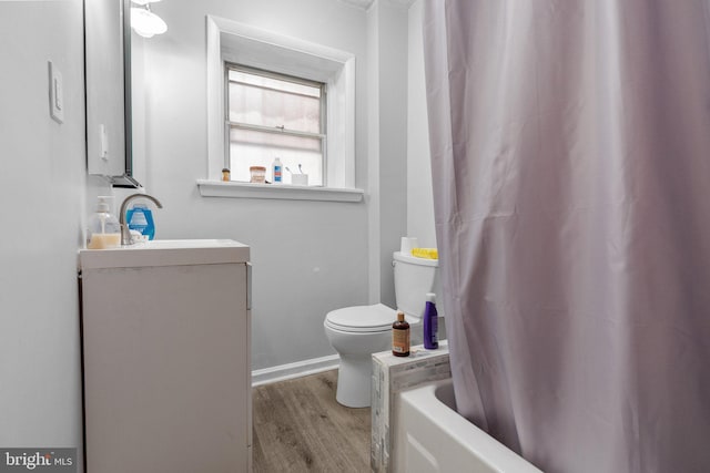 bathroom featuring toilet, sink, and hardwood / wood-style flooring