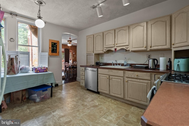 kitchen with hanging light fixtures, track lighting, ceiling fan, sink, and stainless steel dishwasher