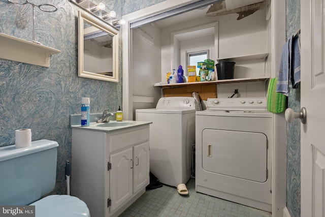 laundry area featuring independent washer and dryer and sink