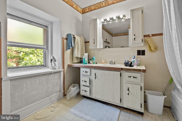 bathroom featuring tile walls, tile patterned floors, and vanity