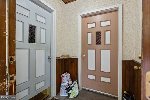 foyer featuring wood walls