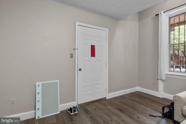 entryway with a textured ceiling and dark hardwood / wood-style floors