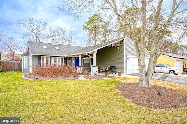 ranch-style home featuring a garage, a porch, and a front lawn