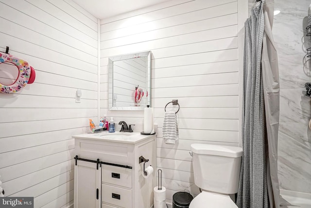 bathroom featuring toilet, vanity, wood walls, and walk in shower