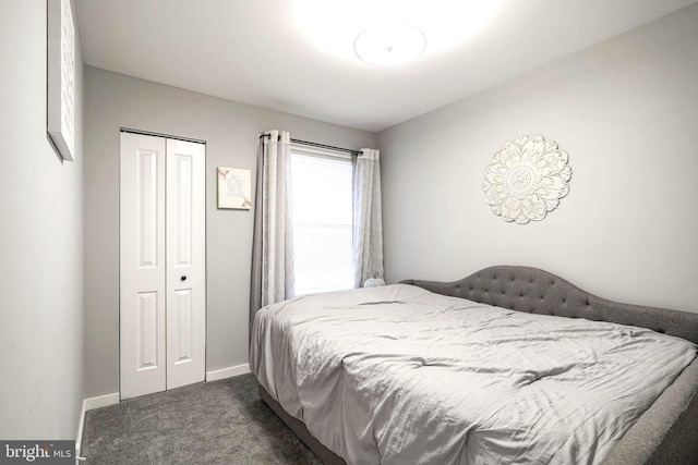 bedroom with dark colored carpet and a closet