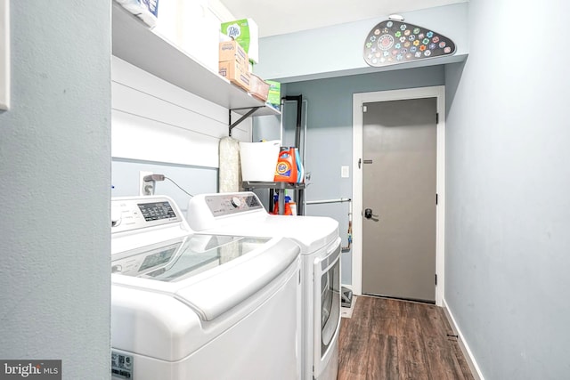 washroom with separate washer and dryer and dark hardwood / wood-style flooring