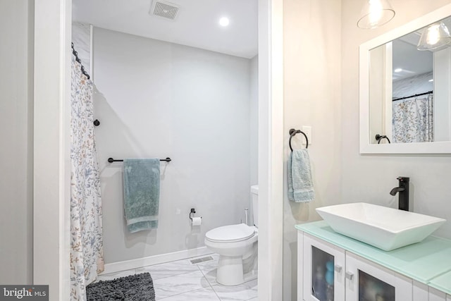 bathroom featuring vanity and toilet