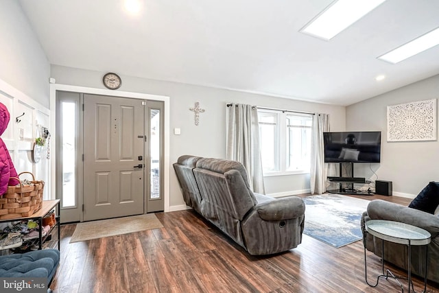 living room with dark hardwood / wood-style flooring and vaulted ceiling